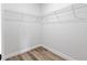 Walk-in closet with wire shelving and wood-look flooring at 4774 Sw 142Nd Place Rd, Ocala, FL 34473
