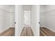 Hallway view into bedroom between two walk-in closets with wire shelving at 4774 Sw 142Nd Place Rd, Ocala, FL 34473