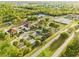 Aerial view of community center, parking, green space, and nearby roads in a neighborhood setting at 4774 Sw 142Nd Place Rd, Ocala, FL 34473