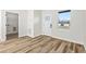 Sunlit entryway featuring wood-look flooring and a view into the laundry room at 4774 Sw 142Nd Place Rd, Ocala, FL 34473