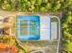 Aerial shot of tennis and pickleball courts with vibrant blue and green surfaces, nestled among trees at 4774 Sw 142Nd Place Rd, Ocala, FL 34473