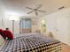 Bright bedroom features ceiling fan, comfortable bed, and adjacent bathroom access for added convenience at 480 Hildalgo Dr, The Villages, FL 32159
