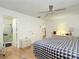 This comfortable bedroom features an ensuite bathroom and a ceiling fan to keep you cool at 480 Hildalgo Dr, The Villages, FL 32159