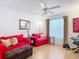 Cozy bedroom with bright walls, natural light, and a comfortable seating area at 480 Hildalgo Dr, The Villages, FL 32159