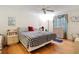 Cozy bedroom featuring hardwood floors, a comfortable bed, and soft, natural light from the window at 480 Hildalgo Dr, The Villages, FL 32159