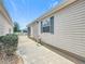 Exterior of the house with green shutters and a glimpse of the screened lanai at 480 Hildalgo Dr, The Villages, FL 32159