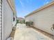 Side view of the house shows a narrow space between two houses with rock ground cover at 480 Hildalgo Dr, The Villages, FL 32159