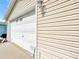 Attached one-car garage with white door and light fixture offering convenient parking and storage at 480 Hildalgo Dr, The Villages, FL 32159