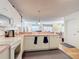 Bright kitchen showcases white cabinets, appliances, laminate counters, and access to living area at 480 Hildalgo Dr, The Villages, FL 32159