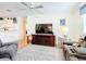 Cozy living room features ceiling fan, wood-style floors, and a comfortable seating arrangement at 480 Hildalgo Dr, The Villages, FL 32159