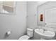 A clean half bathroom featuring a pedestal sink, toilet, and neutral color palette at 5117 Killarney Way, Kissimmee, FL 34746