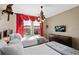 Comfortable bedroom featuring two twin beds, neutral colors, and bright windows at 5117 Killarney Way, Kissimmee, FL 34746