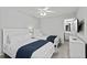 Bright bedroom features two beds, all-white decor, and ensuite bathroom at 5117 Killarney Way, Kissimmee, FL 34746