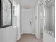 Bright, neutral entryway featuring tile flooring, access to other rooms, and a decorative wall mirror at 5117 Killarney Way, Kissimmee, FL 34746