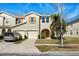 Inviting two-story townhome showcases attached garage, neutral stucco, and a well-manicured front yard at 5117 Killarney Way, Kissimmee, FL 34746