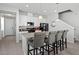 Modern kitchen with white cabinets, stainless steel appliances, and a center island with bar seating at 5117 Killarney Way, Kissimmee, FL 34746