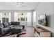 Bright living room boasts a comfortable gray couch, a large window, and neutral decor at 5117 Killarney Way, Kissimmee, FL 34746