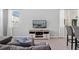 Bright living room with a mounted TV and neutral color palette at 5117 Killarney Way, Kissimmee, FL 34746