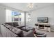 Cozy living room with a large sectional sofa and natural light at 5117 Killarney Way, Kissimmee, FL 34746