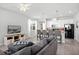 Open-concept living room featuring a comfortable seating area and seamless flow into the kitchen at 5117 Killarney Way, Kissimmee, FL 34746