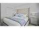 A serene primary bedroom with a tufted headboard, accent lamps and plush bedding at 5117 Killarney Way, Kissimmee, FL 34746