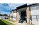 Brick and painted siding two-story apartment building with covered walkway and metal stairs to upper units at 5317 Curry Ford Rd # O201, Orlando, FL 32812