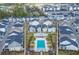 An aerial shot shows the community pool nestled among residential homes and lush green landscaping at 543 Wishbone Ln, Lake Mary, FL 32746