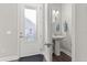 Stylish powder room with pedestal sink and decorative lighting at 543 Wishbone Ln, Lake Mary, FL 32746