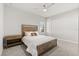 Cozy bedroom with rustic wood furniture, a ceiling fan, and natural light from the window at 543 Wishbone Ln, Lake Mary, FL 32746