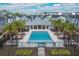 A full view of the community pool and clubhouse, accentuated by palm trees and ample lounge seating at 543 Wishbone Ln, Lake Mary, FL 32746