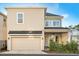 Charming two-story home with a well-maintained lawn, attached garage, and inviting front porch at 543 Wishbone Ln, Lake Mary, FL 32746