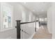 Upstairs hallway featuring natural light from windows and views of the living room at 543 Wishbone Ln, Lake Mary, FL 32746
