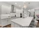 Bright, all-white kitchen features a large island with seating at 543 Wishbone Ln, Lake Mary, FL 32746