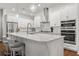 Contemporary kitchen featuring island, stainless steel appliances, and bar stools at 543 Wishbone Ln, Lake Mary, FL 32746