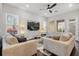 Bright living room features two couches, large windows, and stylish floor lamps for a cozy feel at 543 Wishbone Ln, Lake Mary, FL 32746