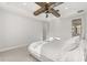 A bright main bedroom boasts a wood beam ceiling fan, tray ceiling and natural light at 543 Wishbone Ln, Lake Mary, FL 32746
