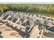 Street view of new homes, displaying a cohesive neighborhood design surrounded by lush green trees at 543 Wishbone Ln, Lake Mary, FL 32746