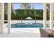 Backyard pool with in-pool loungers and well-manicured landscaping at 571 N Lake Sybelia Dr, Maitland, FL 32751