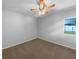 A simple bedroom with tan carpet and a ceiling fan at 6 Almond Trce, Ocala, FL 34472