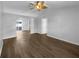 Empty room with hardwood flooring, neutral walls, vaulted ceilings, and an open layout to the dining room at 6 Almond Trce, Ocala, FL 34472