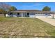 Charming one-story home with blue exterior, white trim, brown roof, and attached garage at 6 Almond Trce, Ocala, FL 34472