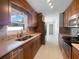 Modern kitchen with stainless steel appliances, warm cabinetry, and tiled backsplash at 6 Almond Trce, Ocala, FL 34472