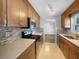 Galley kitchen with wood cabinets, stainless steel appliances, tile backsplash, and granite countertops at 6 Almond Trce, Ocala, FL 34472