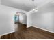 Bright, open living room featuring wood floors and modern chandelier at 6 Almond Trce, Ocala, FL 34472
