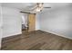 Main bedroom with a barn door leading to the ensuite bathroom with stylish ceiling fan at 6 Almond Trce, Ocala, FL 34472