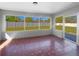 Sunroom with large windows offering views of the fenced backyard at 6 Almond Trce, Ocala, FL 34472