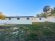 Spacious backyard with an expansive lawn and a secure perimeter fence at 6003 W Harwood Ave, Orlando, FL 32835