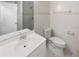 Clean, white bathroom with tiled shower, single sink vanity, and ceramic tile flooring at 6003 W Harwood Ave, Orlando, FL 32835