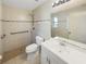Well-maintained bathroom featuring tiled walls, modern sink, and walk-in shower at 6003 W Harwood Ave, Orlando, FL 32835
