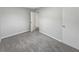 Neutral bedroom with gray carpet and white walls featuring one closet and an ensuite at 6003 W Harwood Ave, Orlando, FL 32835